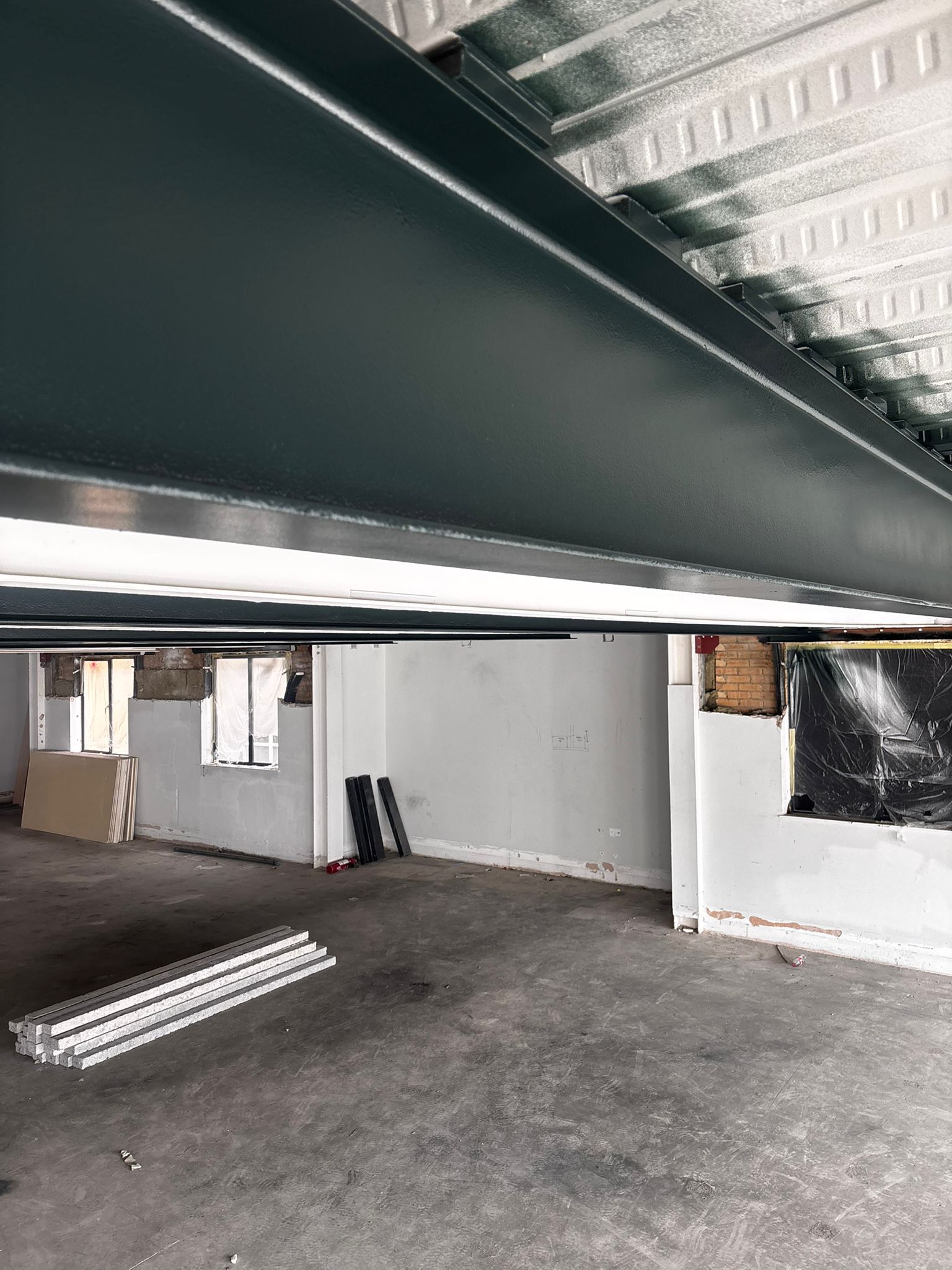 Finished intumescent fire protective coating on structural steel beams